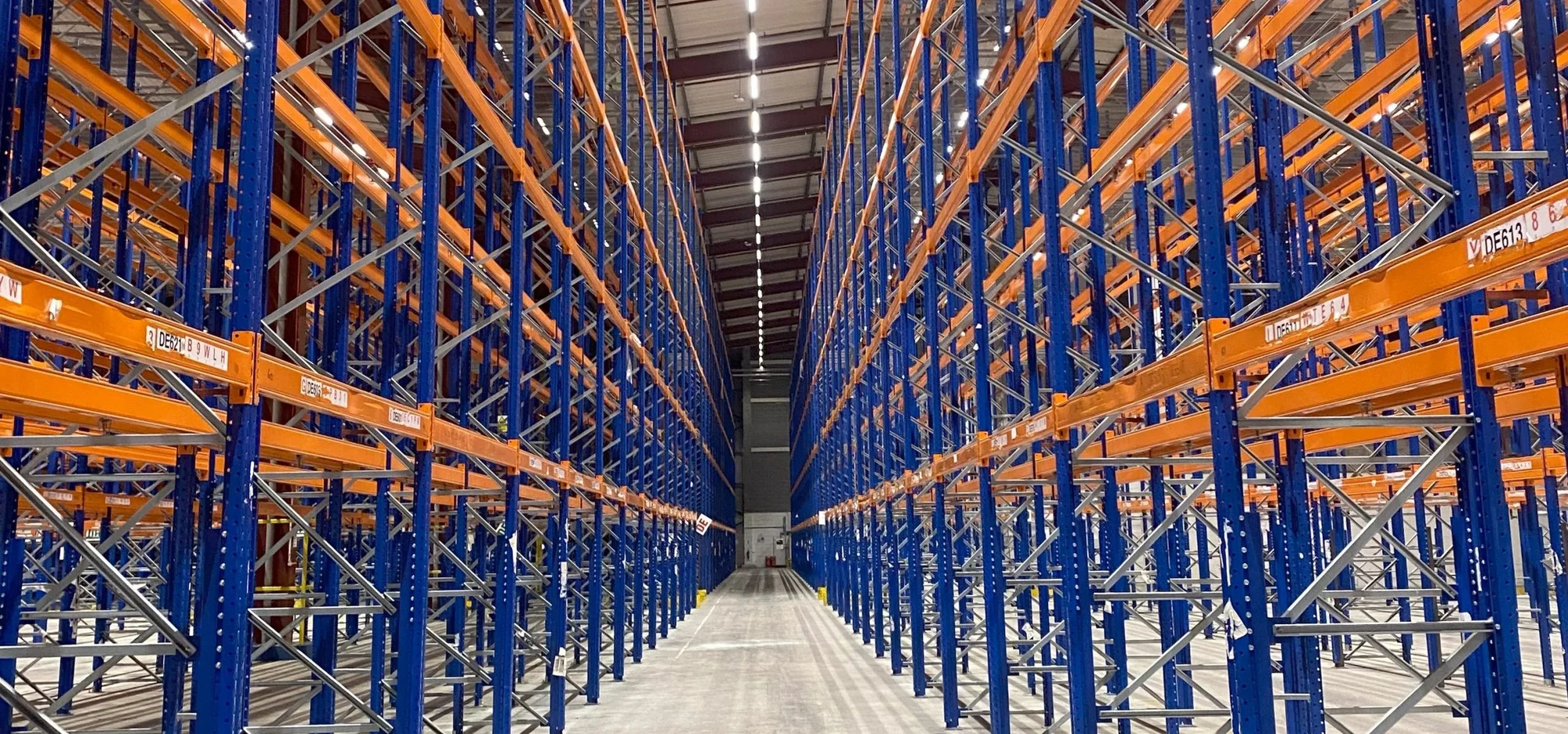 Rows of blue and orange pallet racking inside a warehouse